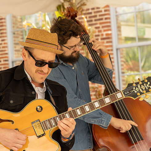 Band performing under tent