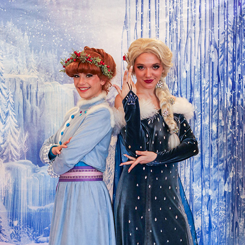Winter sisters posing against an icy background